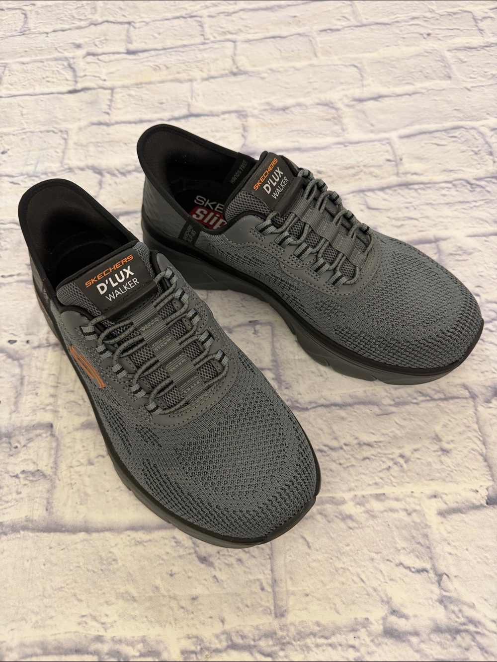 Skechers D'Lux Walker 2.0 Men's Grey Knit Slip-On Athletic Shoes. Orange Accents